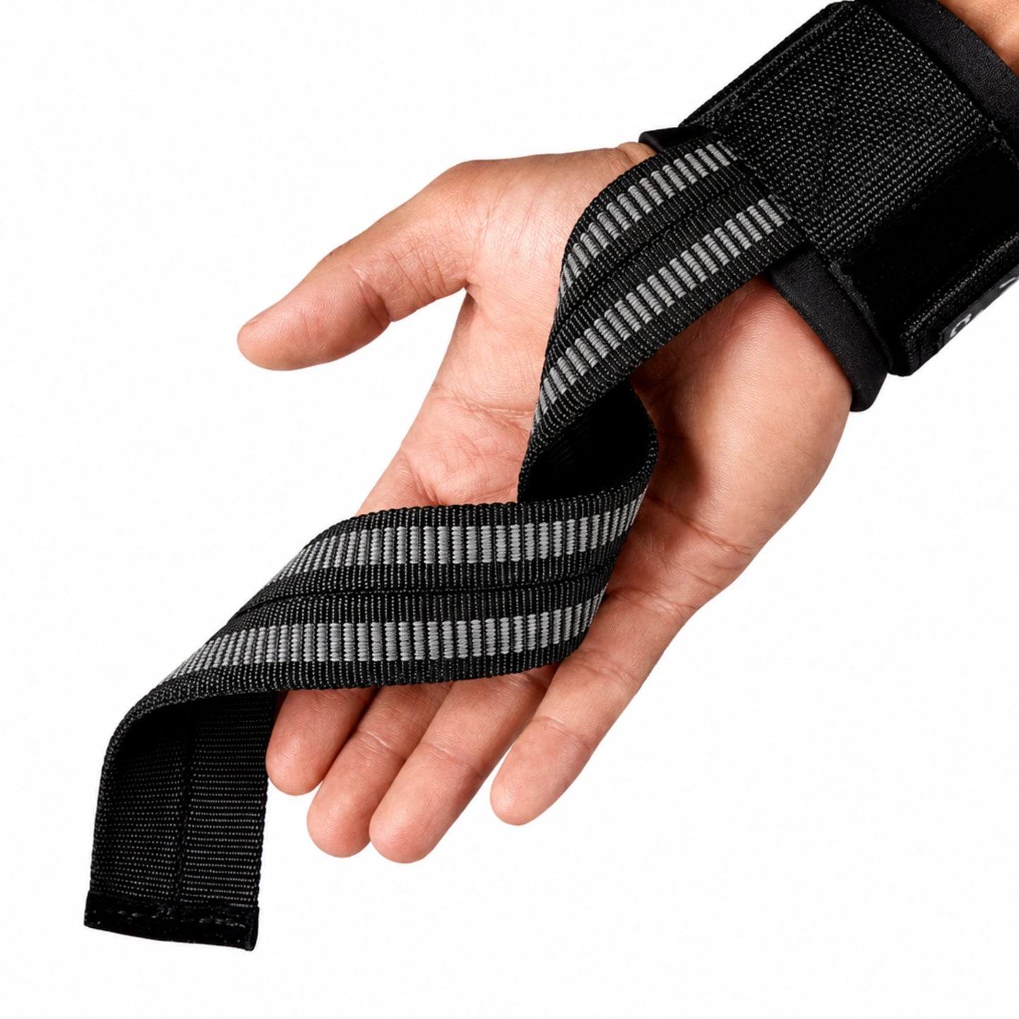 Detalhe da faixa antiderrapante da munhequeira com strap apoiada sobre a mão